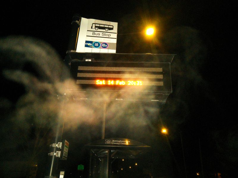 A strange mystical shape in front of a bus stop
