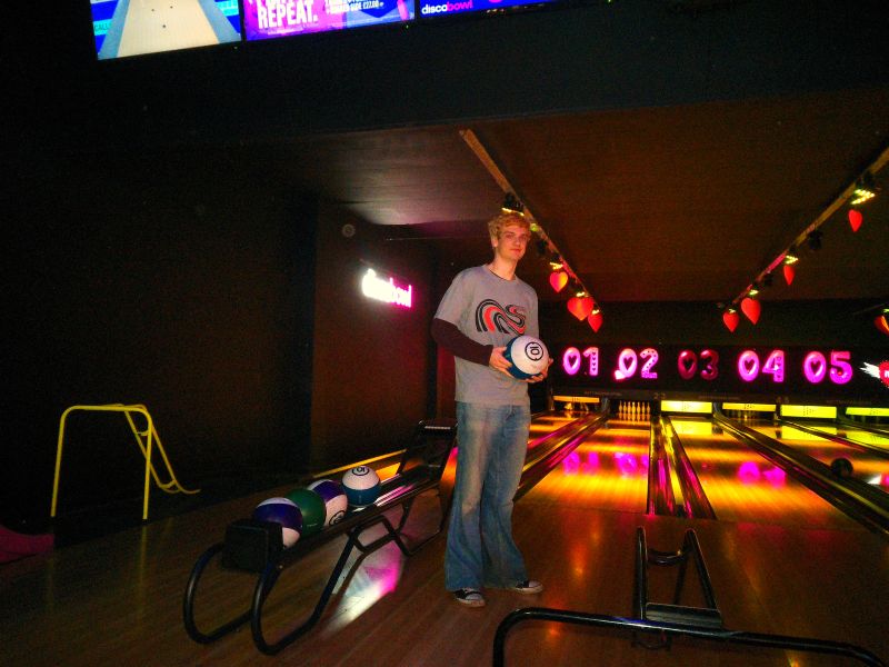 Tom bowling wearing his Figure 8 t-shirt